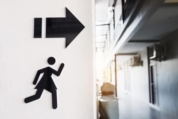 Sign of woman toilet on white cement wall background. OVERACTIVE BLADDER