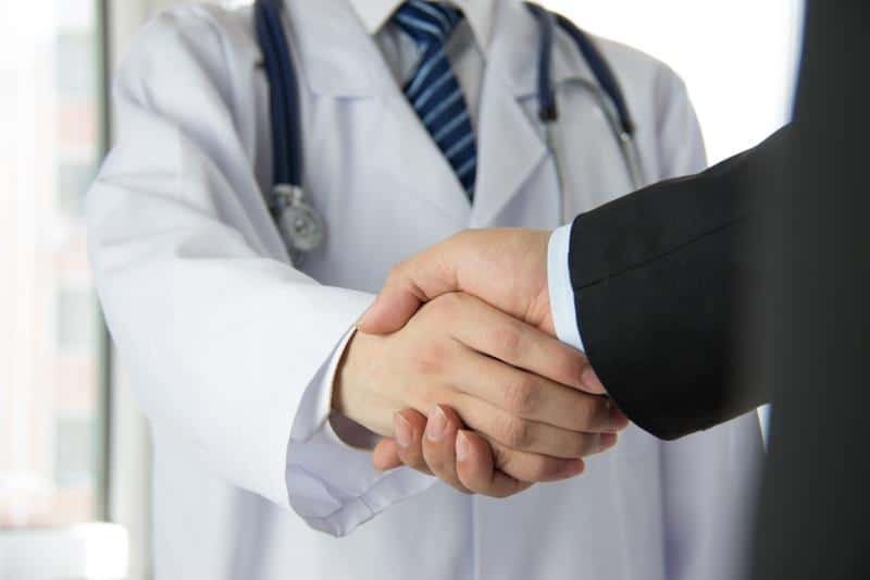 doctor shaking hands with man in suit